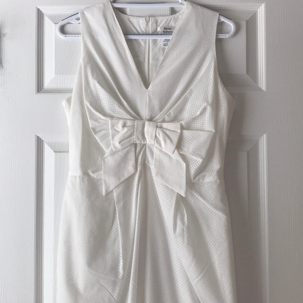 White dress with bow front detail.